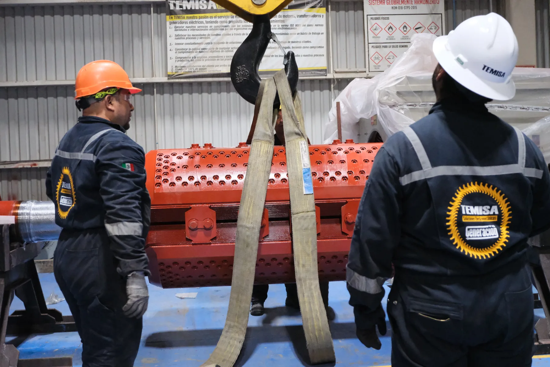 Cuadrilla de TEMISA maniobrando un rotor con eslingas y grúa en el taller