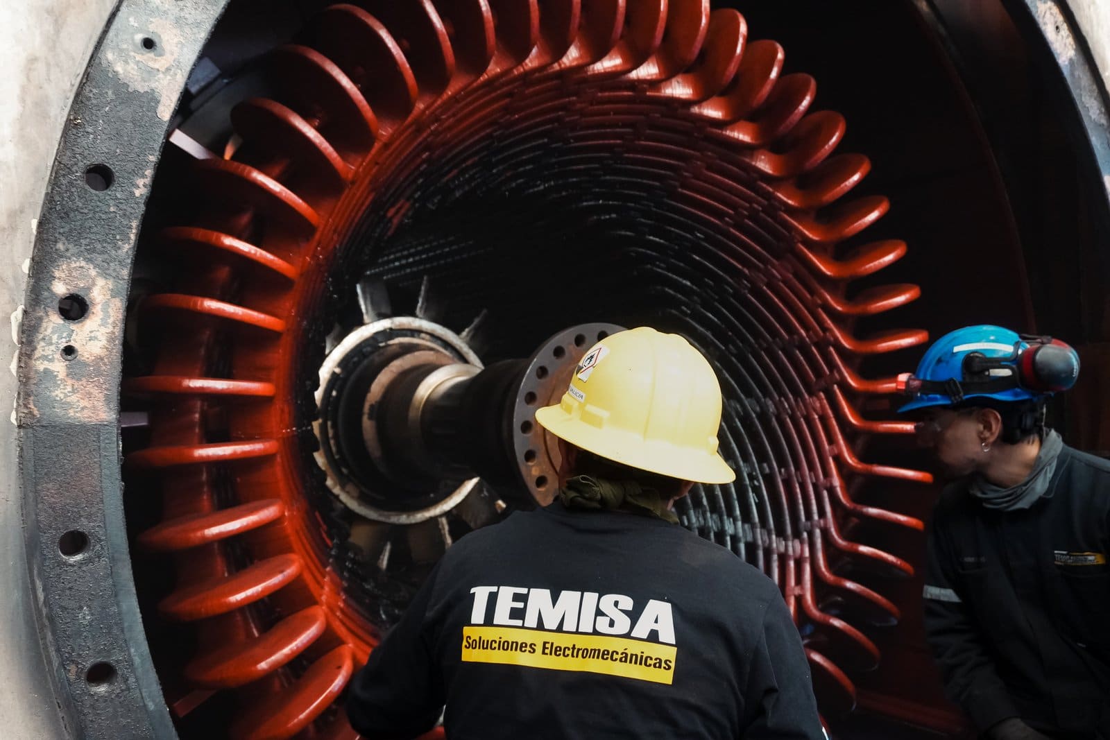 Técnico inspeccionando el estator de un generador síncrono durante mantenimiento